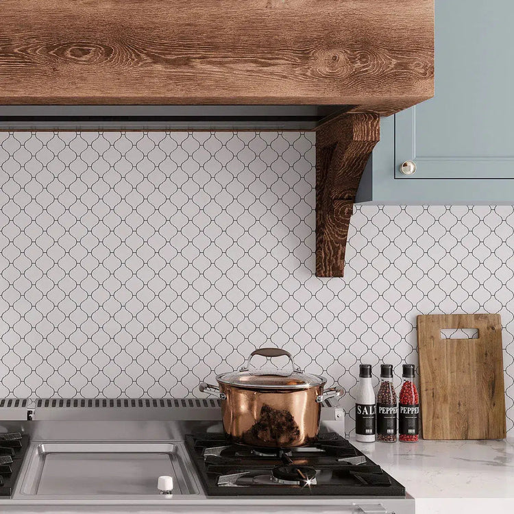 White Marble Arabesque Tile Backsplash with a marble countertop and wood range hood